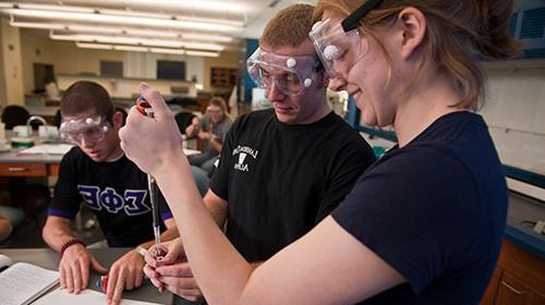B-to-MD students in lab with safety glasses on.